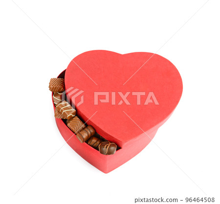 Chocolate sweets in a red heart shaped box isolated on white background. Chocolate sweets in a red heart shaped box isolated on white background. 96464508
