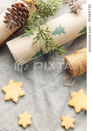 Wrapping paper with a pine branch and Christmas cookies on a textile background Wrapping paper with a pine branch and Christmas cookies on a textile background 96464736