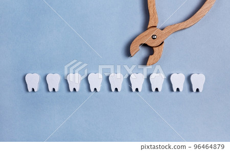 Teeth row with forceps. Surgical tooth extraction or dental implantation. Removal operation. Health care, stomatology concept. Kids toy. 96464879