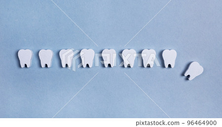 Tooth loss. Teeth row with missing, fallen one on blue background. Poor oral hygiene and dental care, periodontal diseases, injury Tooth loss. Teeth row with missing, fallen one on blue background. Poor oral hygiene and dental care, periodontal diseases, injury 96464900