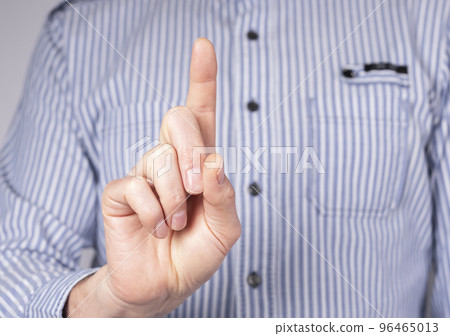 Man with index finger raised upwards. Forefinger pointing to top. Attention, count gesture. Man with index finger raised upwards. Forefinger pointing to top. Attention, count gesture. 96465013