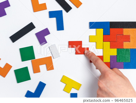 Hand doing puzzle. Critical thinking, decision making, concentration concept. Important missing element adding. 96465025