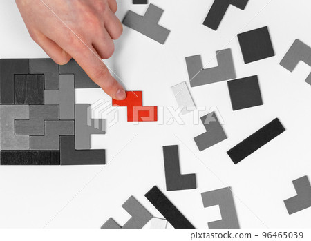 Hand putting outstanding puzzle piece. Analytic thinking, solution finding concept. Vital missing element adding. Uniqueness, standing out from crowd, individuality concept 96465039