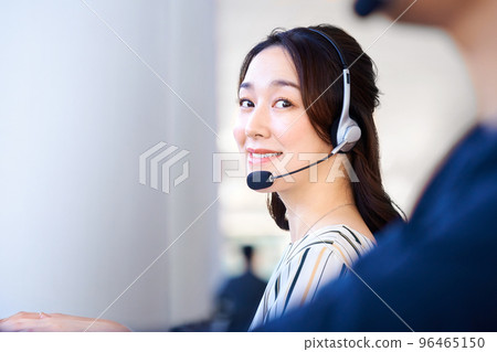 Casually dressed female operator chatting at the office counter Casually dressed female operator chatting at the office counter 96465150