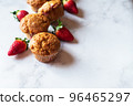 Strawberry muffins on a white marble background. Top view and copy space. 96465297