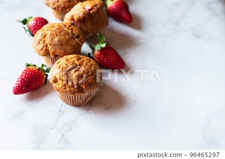 Strawberry muffins on a white marble background. Top view and copy space. Strawberry muffins on a white marble background. Top view and copy space. 96465297