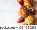 Strawberry muffins on a white marble background. Top view and copy space. 96465299