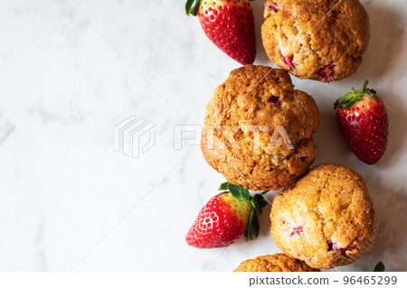 Strawberry muffins on a white marble background. Top view and copy space. 96465299