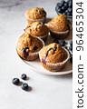 Blueberry muffins  served on a white plate on a marble background. 96465304