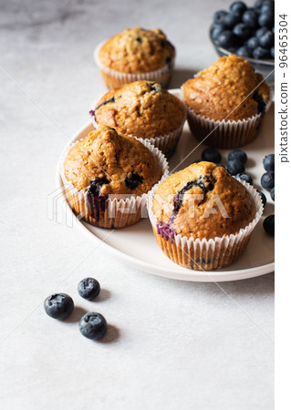Blueberry muffins  served on a white plate on a marble background. 96465304