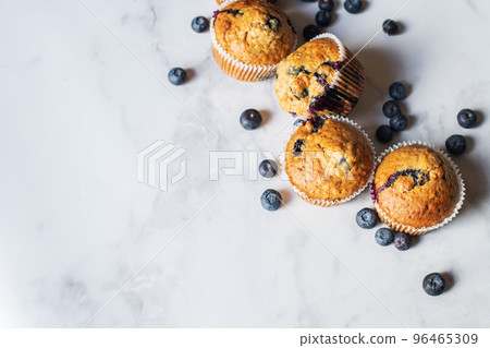 Blueberry muffins on a white marble background. Blueberry muffins on a white marble background. 96465309