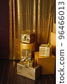 Stack of colorful gift boxes in golden wrapping paper with ribbons 96466013