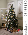 Christmas tree with presents underneath in living room 96466180