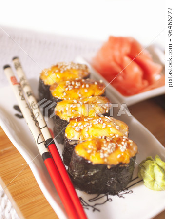 hot sushi with roe and chopsticks. close up hot sushi with roe and chopsticks. close up 96466272