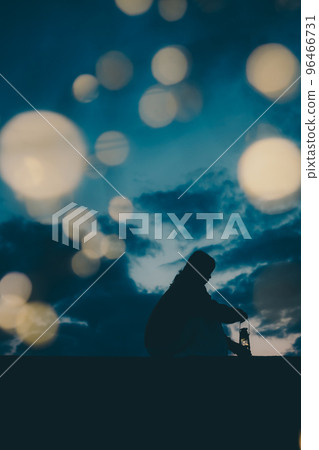 Silhouette photo of a young woman standing by the sea Silhouette photo of a young woman standing by the sea 96466731