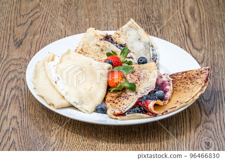 pancake with fruit and marmalade for breakfast and as dessert 96466830