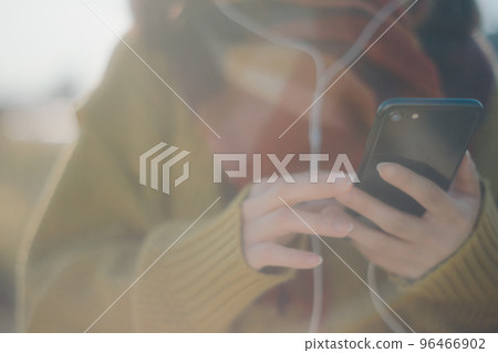 一位年輕女子站在河床上聽音樂的照片 一位年輕女子站在河床上聽音樂的照片 96466902