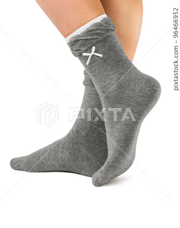 Side view of beautiful woman foot dressed in new nice and soft natural cotton fabric blank grey socks with light grey edging Side view of beautiful woman foot dressed in new nice and soft natural cotton fabric blank grey socks with light grey edging 96466952