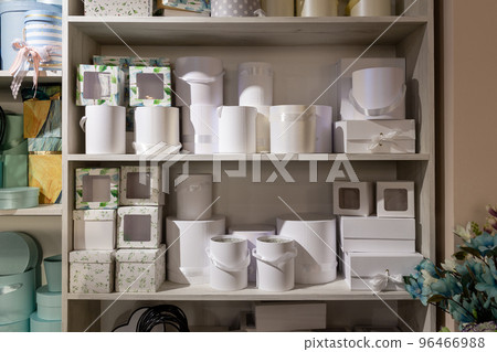 Close-up of decorative boxes for packing flowers on a shelf in a flower shop. 96466988