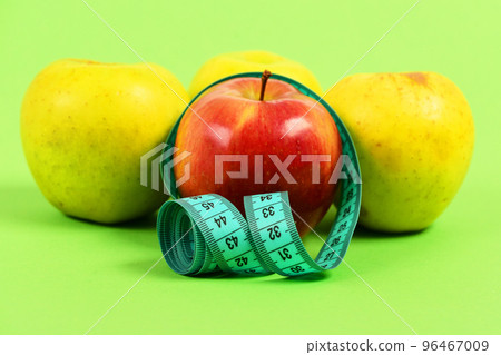 Composition of four apples and tape for measuring 96467009