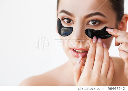 Female face with black patches under eyes 96467242
