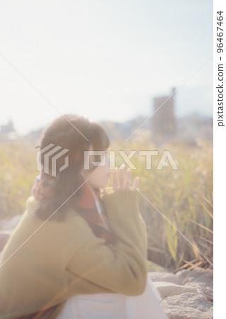 A photo of a young woman standing on the riverbed while listening to music 96467464