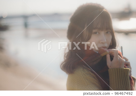 A photo of a young woman standing on the riverbed while listening to music A photo of a young woman standing on the riverbed while listening to music 96467492