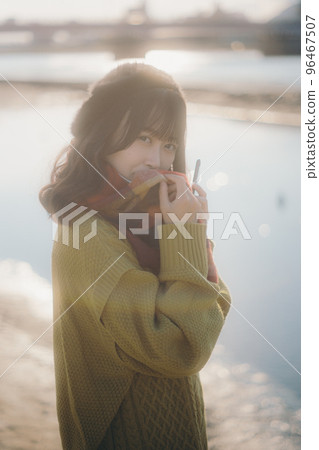 A photo of a young woman standing on the riverbed while listening to music A photo of a young woman standing on the riverbed while listening to music 96467507