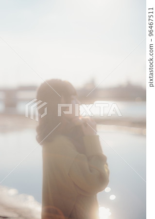 A photo of a young woman standing on the riverbed while listening to music A photo of a young woman standing on the riverbed while listening to music 96467511