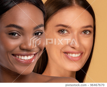 Closeup of attractive multiracial young women smiling at camera Closeup of attractive multiracial young women smiling at camera 96467670