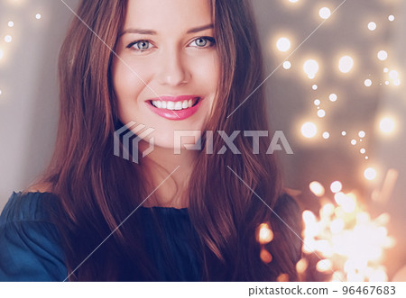 Holiday magic, Christmas and New Year celebration, happy woman with sparklers, portrait Holiday magic, Christmas and New Year celebration, happy woman with sparklers, portrait 96467683