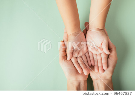 Closeup top view family hands stack palms studio shot isolated on green background, parents and kid holding empty free space on hand together, Gesture sign of support and love, Family and parents day Closeup top view family hands stack palms studio shot isolated on green background, parents and kid holding empty free space on hand together, Gesture sign of support and love, Family and parents day 96467827