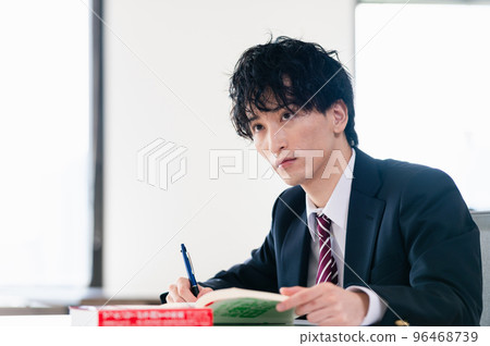 Male high school student studying for exam Male high school student studying for exam 96468739