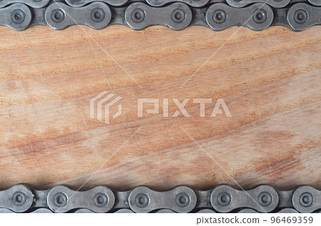 Dirty and oily chain from a mountain bike lying on a wooden table in a bicycle shop Dirty and oily chain from a mountain bike lying on a wooden table in a bicycle shop 96469359