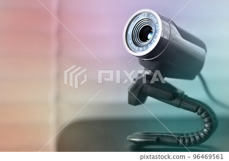 Wired web camera lying on the computer surface. Close up view Wired web camera lying on the computer surface. Close up view 96469561