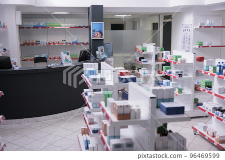 Bright empty drugstore equipped shelves full of supplements, pills, vitamin package. Drugstore with nobody in it ready for opening to customer. Health care products, medicine service support Bright empty drugstore equipped shelves full of supplements, pills, vitamin package. Drugstore with nobody in it ready for opening to customer. Health care products, medicine service support 96469599