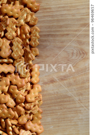 Many salted crackers on a cutting board with copy space 96469657