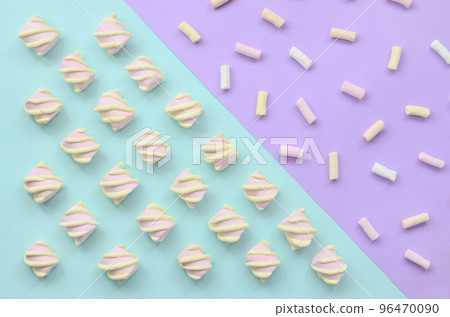 Colorful marshmallow laid out on violet and blue paper background. pastel creative textured pattern. minimal 96470090