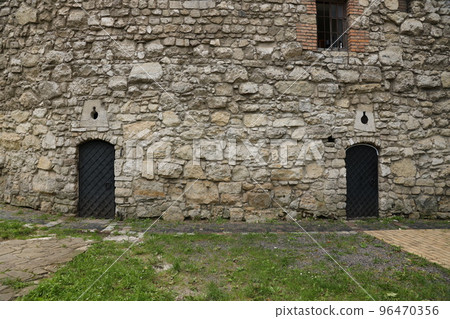 Texture of medieval stone wall and old metal door Texture of medieval stone wall and old metal door 96470356