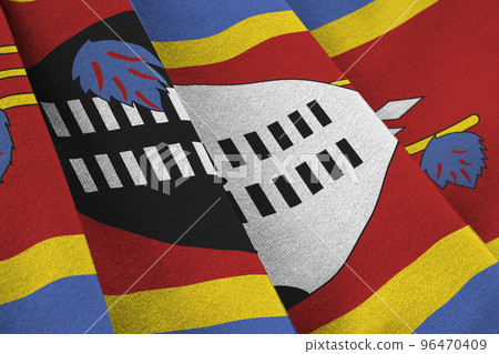 Swaziland flag with big folds waving close up under the studio light indoors. The official symbols and colors in banner 96470409