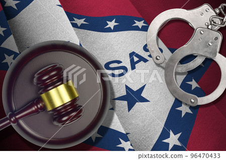 Arkansas US state flag with judge mallet and handcuffs in dark room. Concept of criminal and punishment 96470433