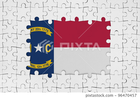North Carolina US state flag in frame of white puzzle pieces with missing central part North Carolina US state flag in frame of white puzzle pieces with missing central part 96470457