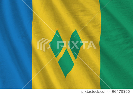 Saint Vincent and the Grenadines flag with big folds waving close up under the studio light indoors. The official symbols and colors in banner Saint Vincent and the Grenadines flag with big folds waving close up under the studio light indoors. The official symbols and colors in banner 96470500