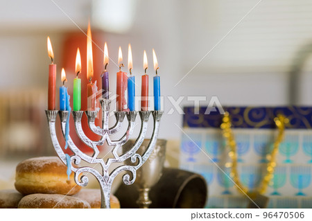 Celebration Hanukkah is based on Judaism tradition of lighting candles in hanukkiah menorah as symbol holiday Celebration Hanukkah is based on Judaism tradition of lighting candles in hanukkiah menorah as symbol holiday 96470506