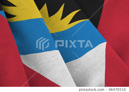 Antigua and Barbuda flag with big folds waving close up under the studio light indoors. The official symbols and colors in banner Antigua and Barbuda flag with big folds waving close up under the studio light indoors. The official symbols and colors in banner 96470516