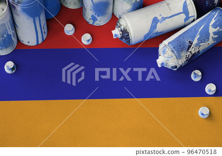 Armenia flag and few used aerosol spray cans for graffiti painting. Street art culture concept 96470518