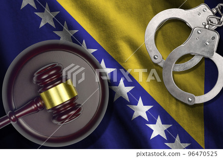 Bosnia and Herzegovina flag with judge mallet and handcuffs in dark room. Concept of criminal and punishment, background for judgement topics 96470525
