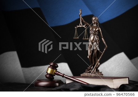 Estonia flag with statue of lady justice, constitution and judge hammer on black drapery. Concept of judgement and guilt Estonia flag with statue of lady justice, constitution and judge hammer on black drapery. Concept of judgement and guilt 96470566