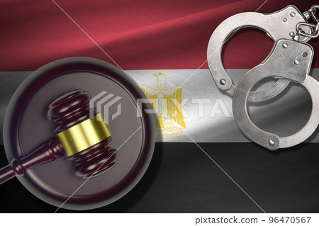 Egypt flag with judge mallet and handcuffs in dark room. Concept of criminal and punishment, background for judgement topics Egypt flag with judge mallet and handcuffs in dark room. Concept of criminal and punishment, background for judgement topics 96470567