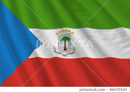 Equatorial Guinea flag with big folds waving close up under the studio light indoors. The official symbols and colors in banner 96470584